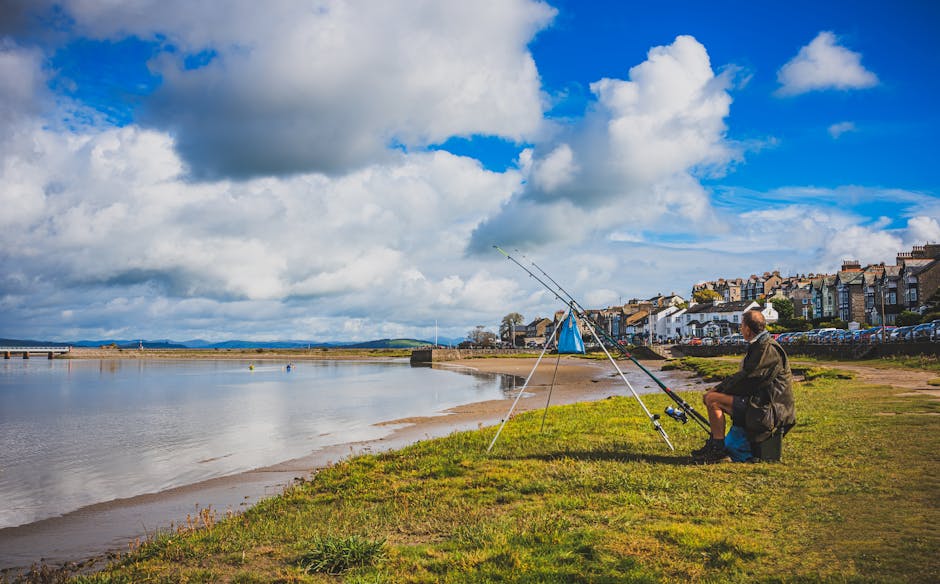Tranquil seaside fishing scene on Arnside beach, England, with a fisherman and vibrant sky.